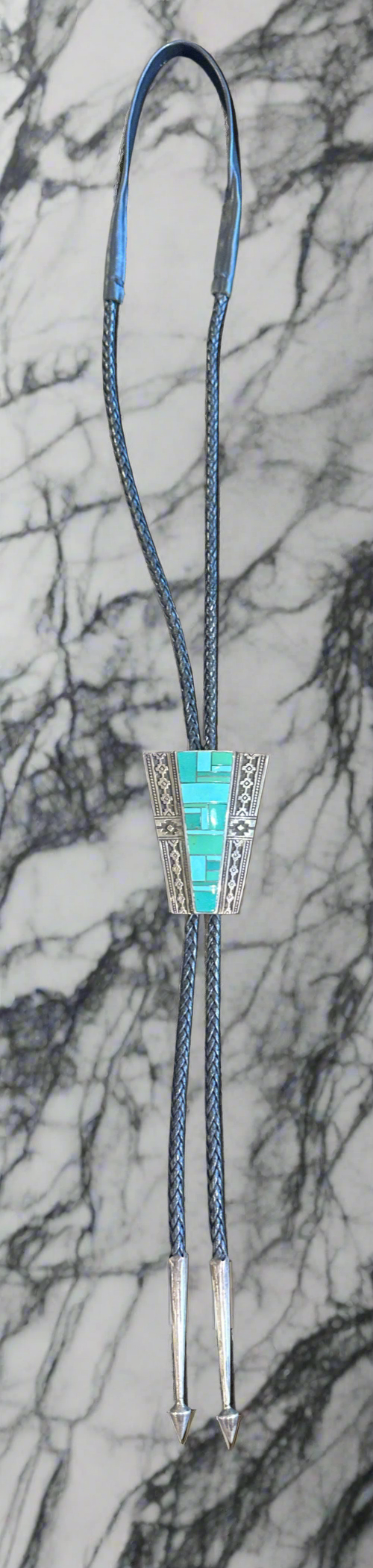 Bolo Tie with inlaid Turquoise in it made by super smith.