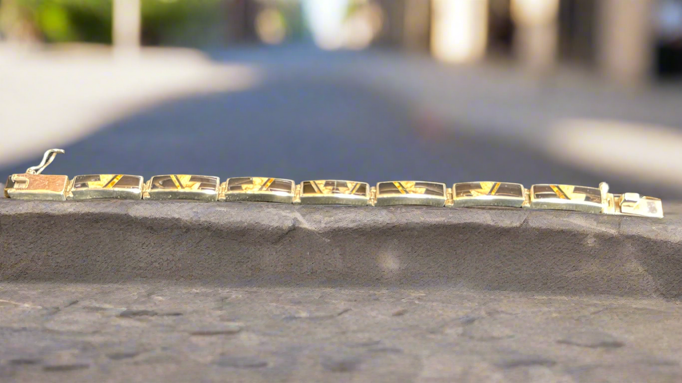 Native Earth link bracelet with Seven links. It has Picture Jasper, Tigers Eye, and Black Jade. Made by Super Smith Inc.