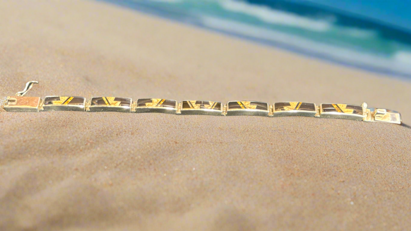 Native Earth link bracelet with Seven links. It has Picture Jasper, Tigers Eye, and Black Jade. Made by Super Smith Inc.